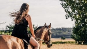 Woman with autism riding horse overcoming challenges
