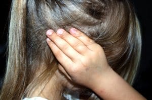 child holding ears with sensory overload