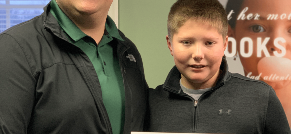 LearningRx Staunton-Harrisonburg: Male staff member with boy student getting a certificate