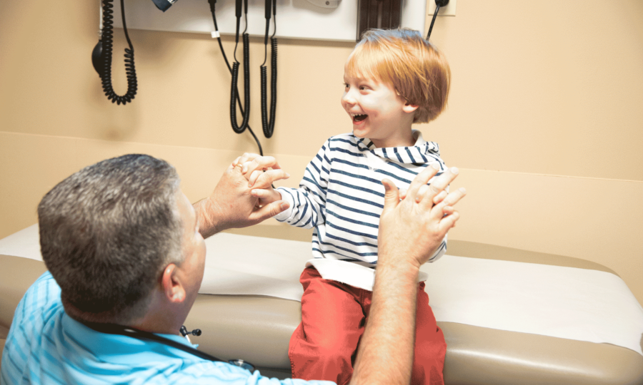 male doctor working with young child at St. Tammany Pediatrics Clinic