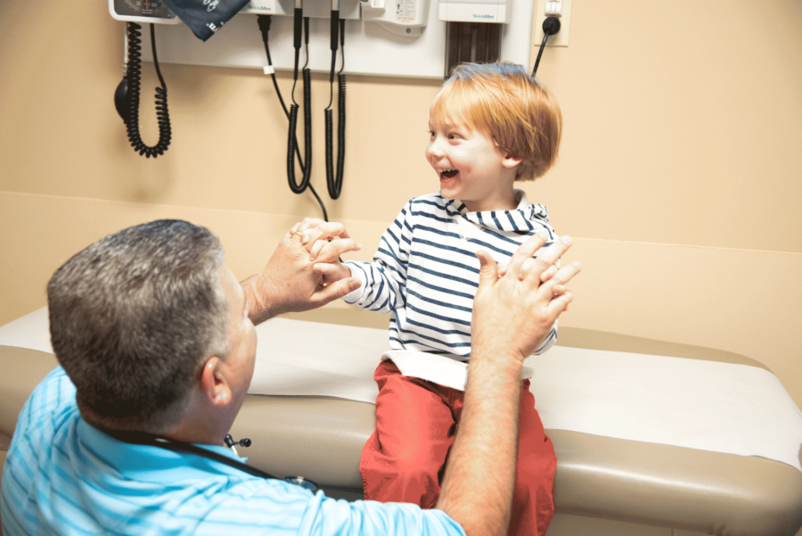 male doctor working with young child at St. Tammany Pediatrics Clinic