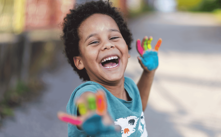 Smiling boy with paint on his hands